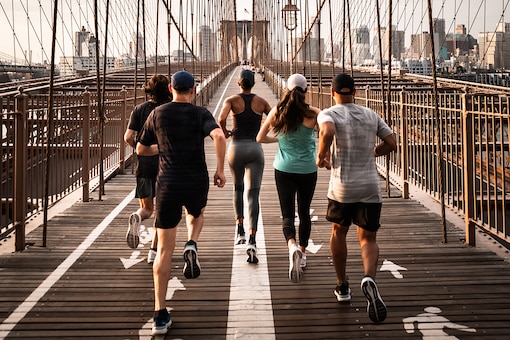 Läufer in New York City, Jogger, Menschen in Sportklamotten laufen über eine Brücke